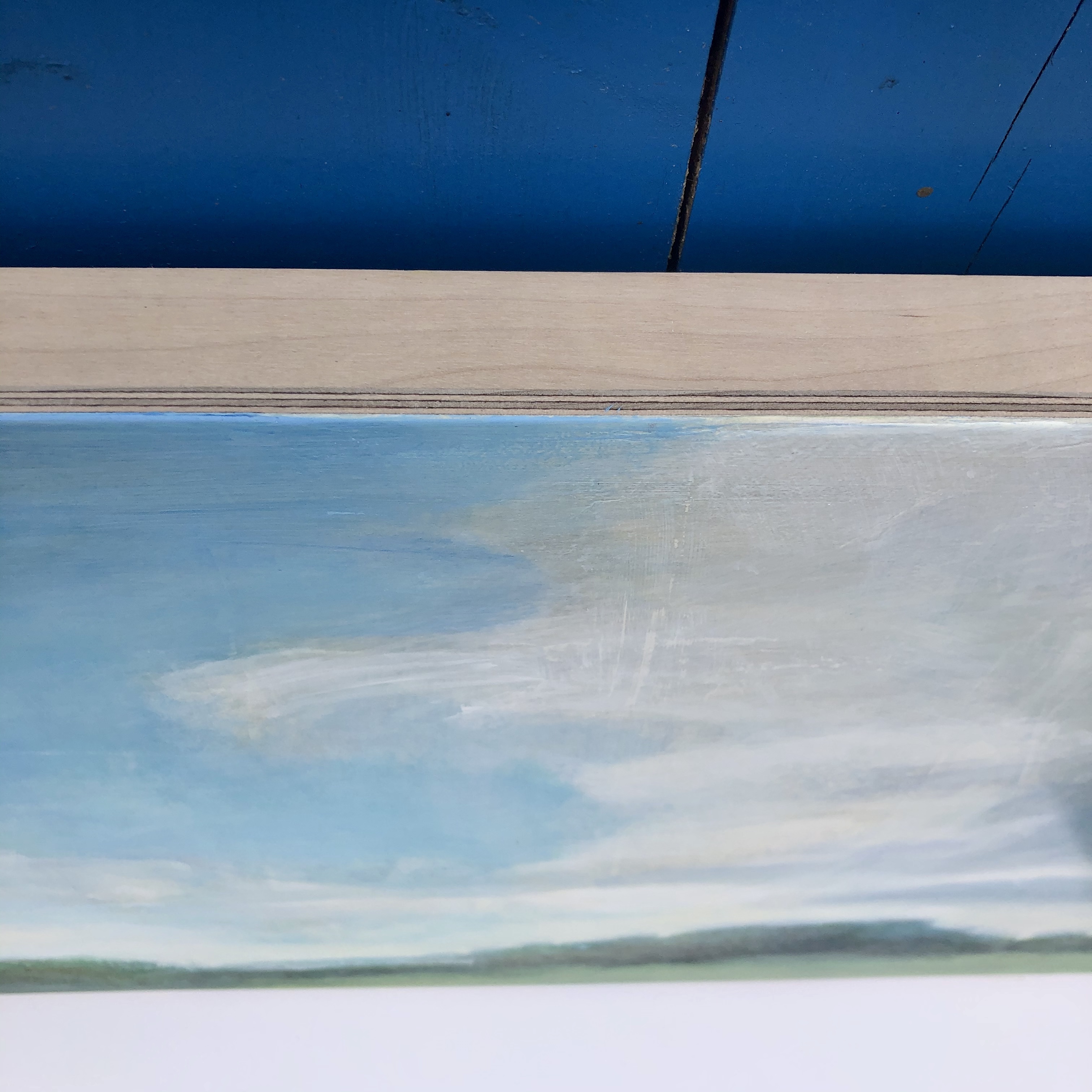 edge of painting showing bare wood